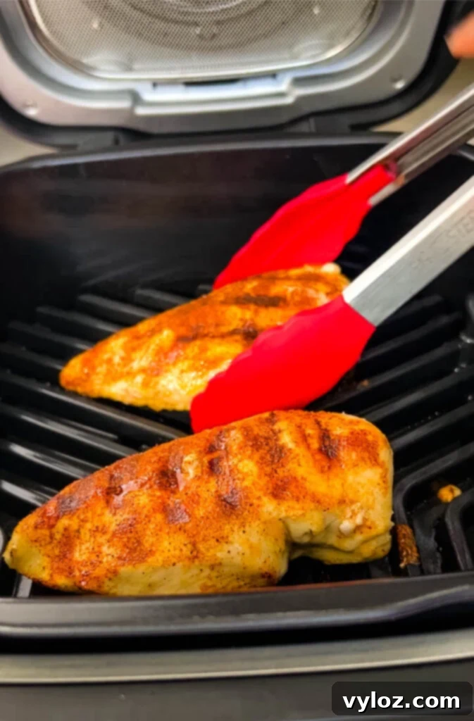 Perfectly cooked chicken breast with grill marks on a Ninja Foodi indoor grill