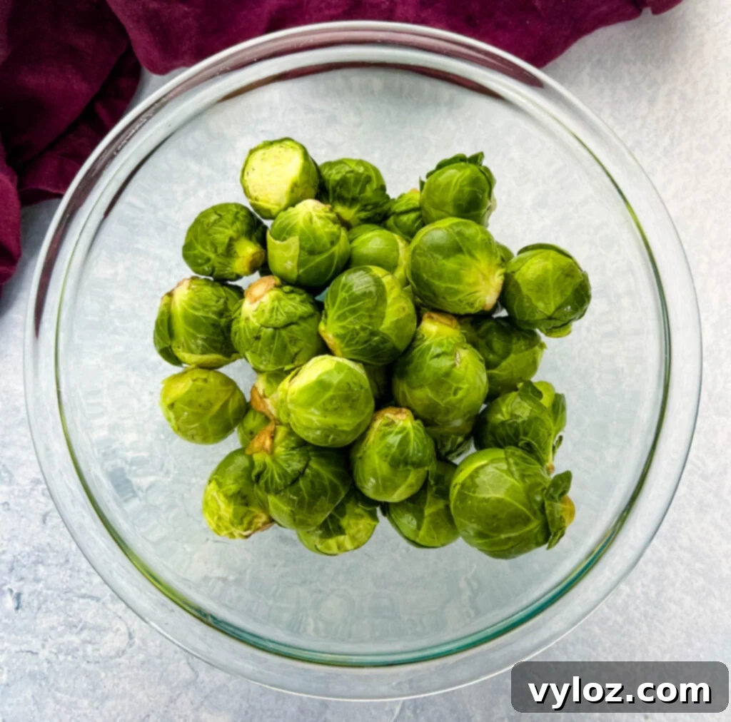 Caramelized Garlic Brussels Sprouts 3 Raw fresh Brussels sprouts in a glass bowl, ready for preparation