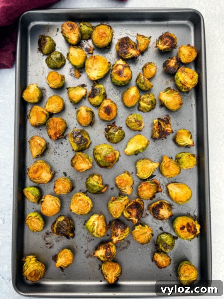 Caramelized Garlic Brussels Sprouts 8 Garlic Brussels sprouts spread out on a sheet pan, ready for the oven