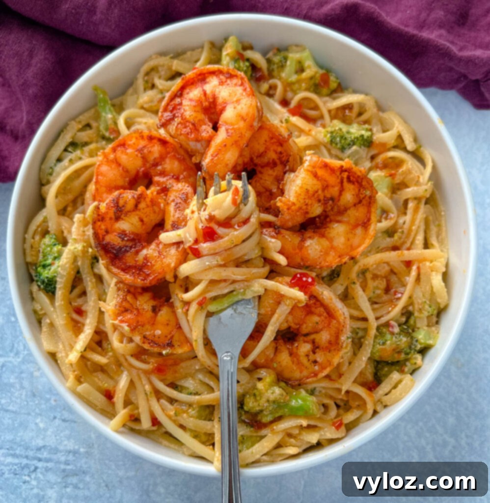 bang bang shrimp pasta in a white bowl with a fork