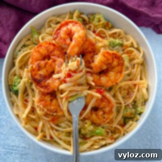 bang bang shrimp pasta in a white bowl with a fork