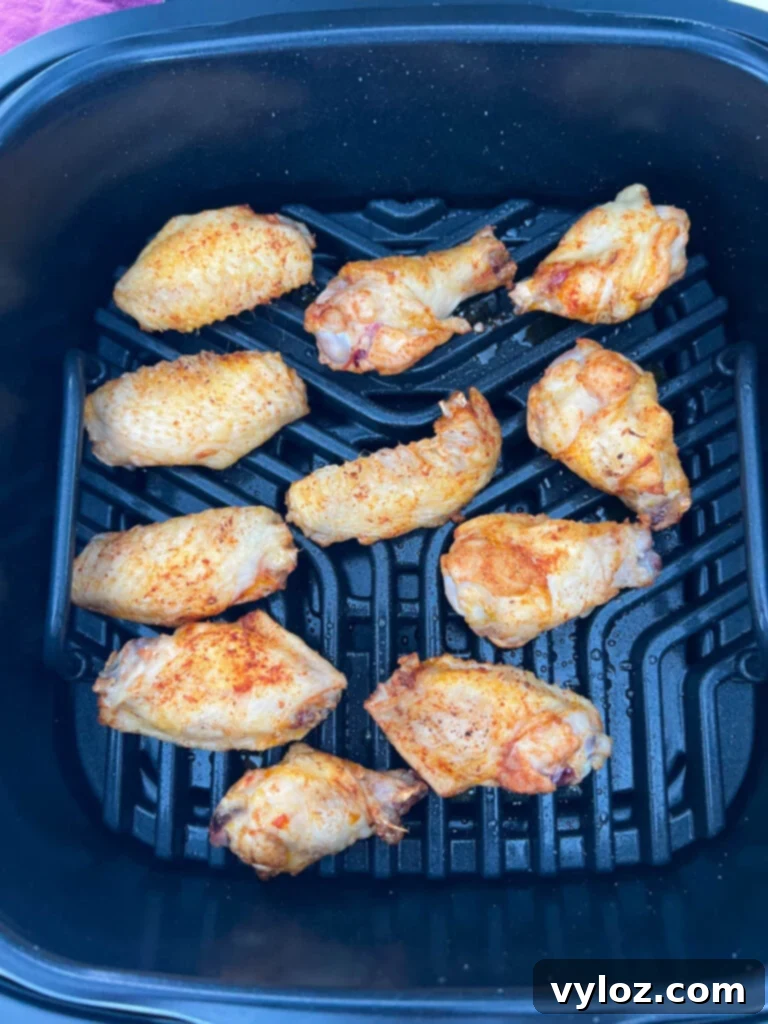 Raw chicken wings arranged on the grate of an indoor Ninja Foodi Grill, ready to cook.