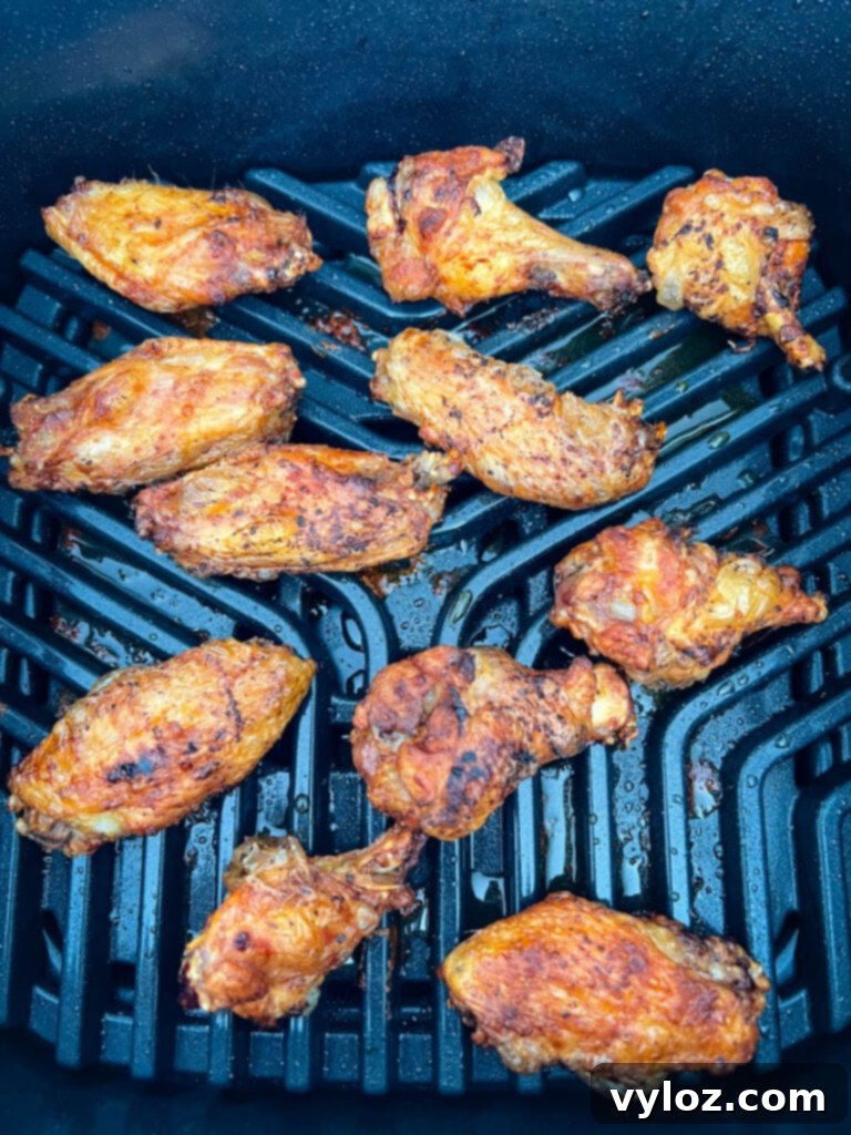 Perfectly grilled chicken wings on an indoor smokeless Ninja Foodi Grill, ready to be served.