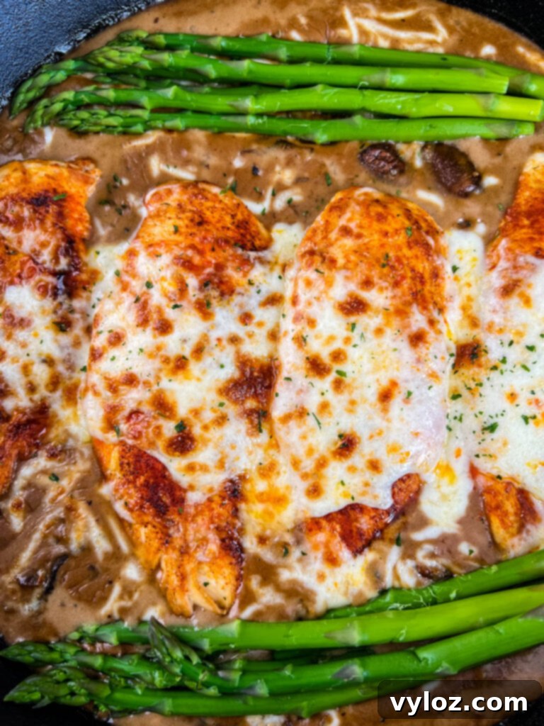 Cheesecake factory copycat chicken Madeira in a skillet with asparagus