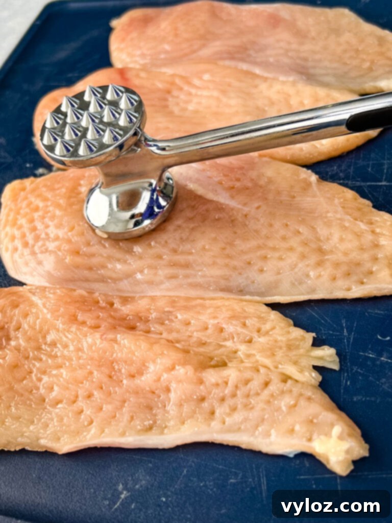 mallet pounding raw chicken breast
