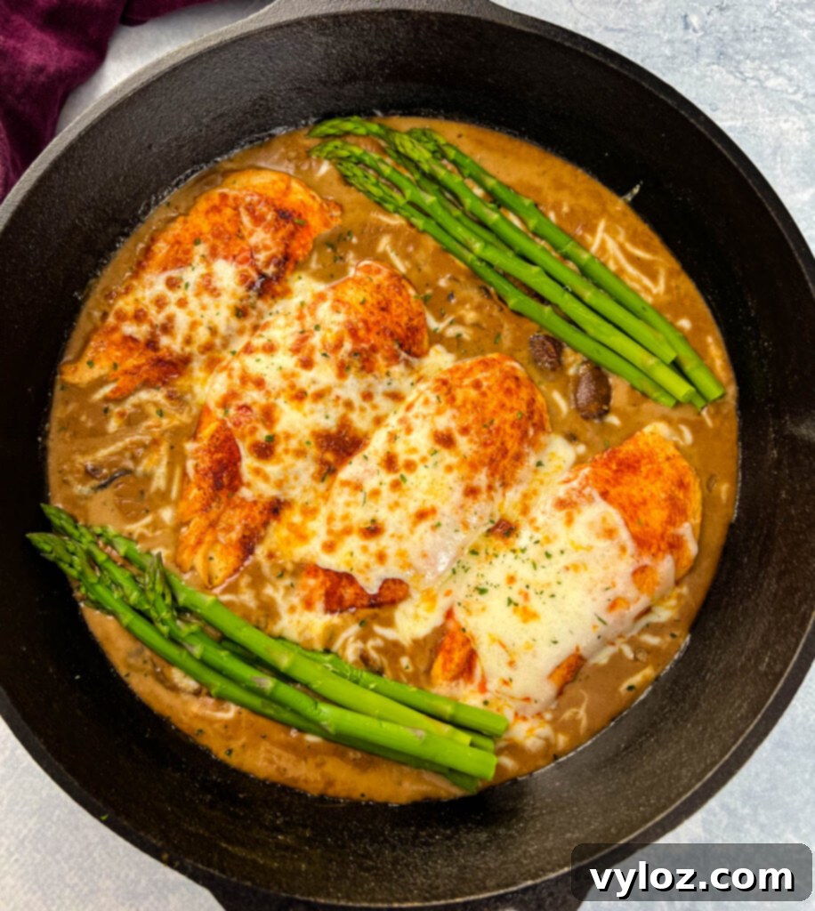 Cheesecake factory copycat chicken Madeira in a skillet with asparagus
