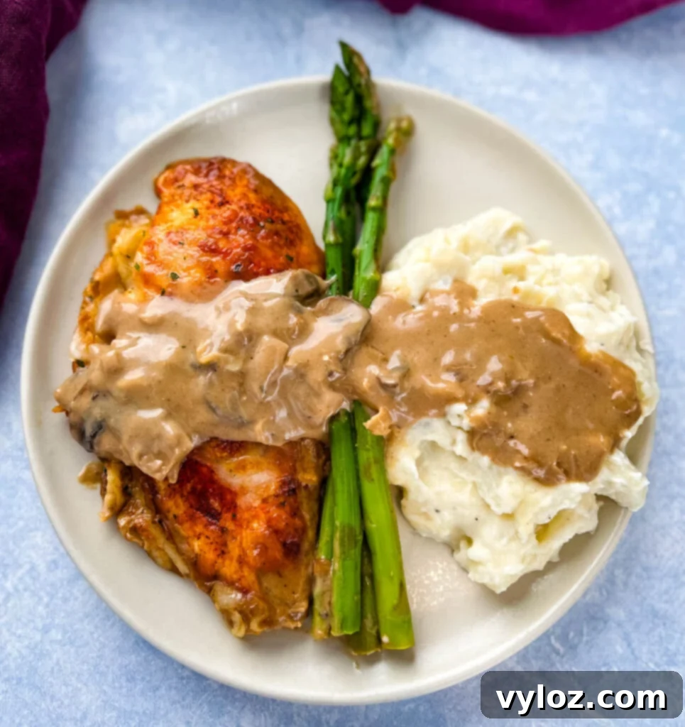 Chicken Madeira with mashed potatoes and asparagus on a plate