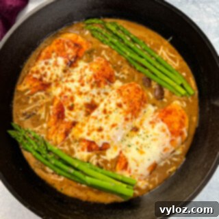 Cheesecake factory copycat chicken Madeira in a skillet with asparagus