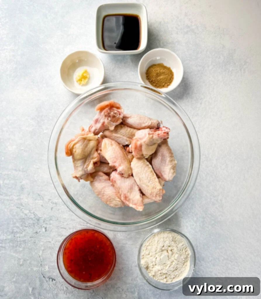 Sweet Chili Chicken Wings: A Flavorful Journey 3 raw chicken wings, soy sauce, sweet chili sauce, garlic, flour, and spices in separate bowls