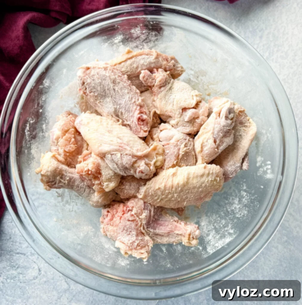 Sweet Chili Chicken Wings: A Flavorful Journey 4 chicken wings in a glass bowl, ready for seasoning