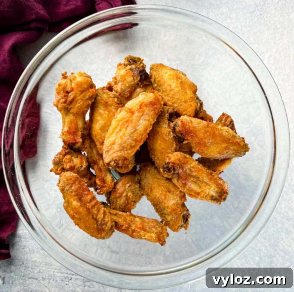Sweet Chili Chicken Wings: A Flavorful Journey 8 fried or baked wings in a glass bowl, ready to be sauced