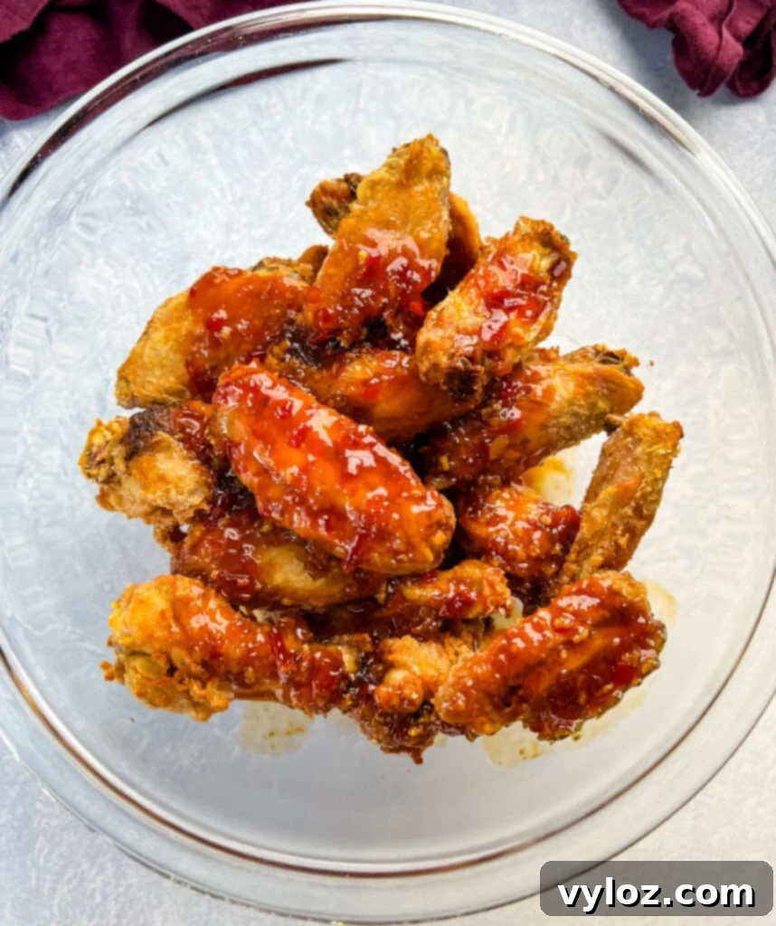 Sweet Chili Chicken Wings: A Flavorful Journey 9 sweet chili wings in a glass bowl, garnished and ready to serve