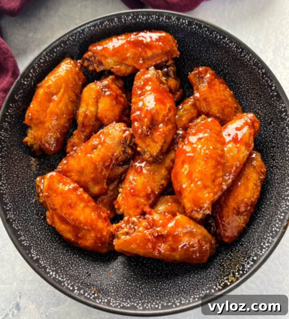 Sticky Honey Garlic Wings 9 A large bowl filled with succulent honey garlic chicken wings, garnished and ready for serving.
