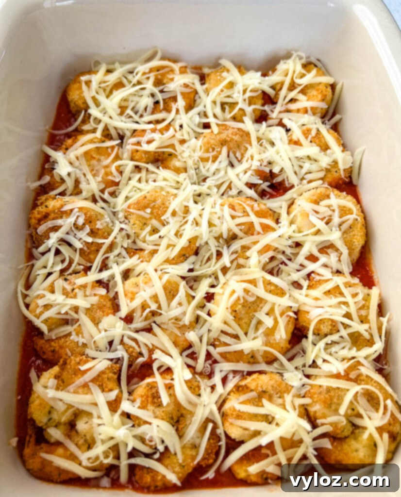 Shrimp Parmesan with melted mozzarella cheese in a baking dish, fresh from the oven.