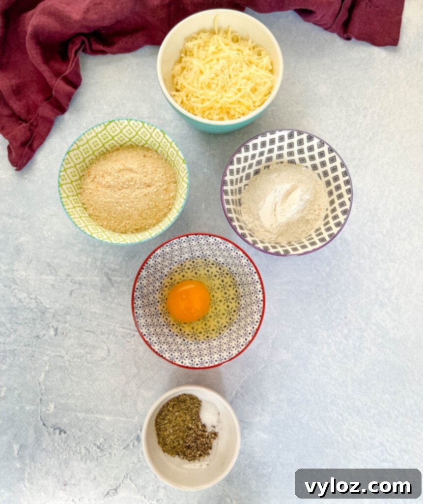 mozzarella cheese, breadcrumbs, flour, egg, and Italian seasoning in separate bowls