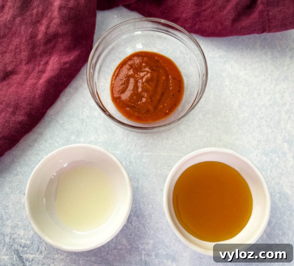 Ultimate Traeger Smoked Salmon 6 Individual bowls containing BBQ sauce, honey, and fresh lemon juice, prepared for mixing into the glaze.