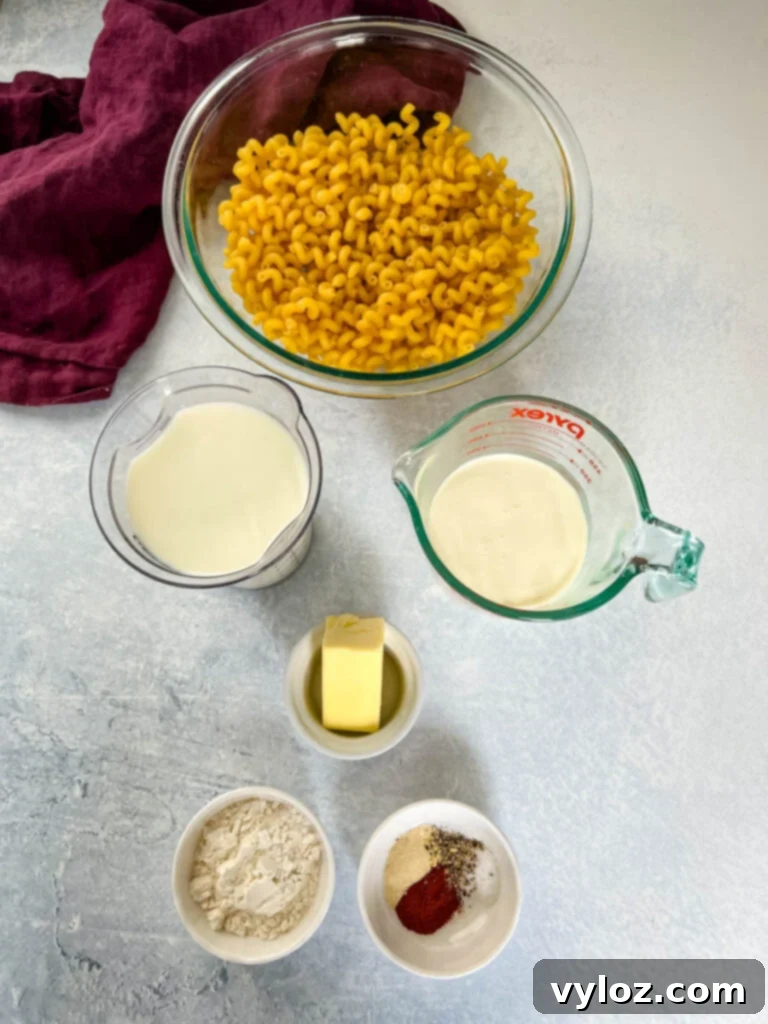 pasta, milk, heavy whipping cream, butter, spices, and flour in separate bowls