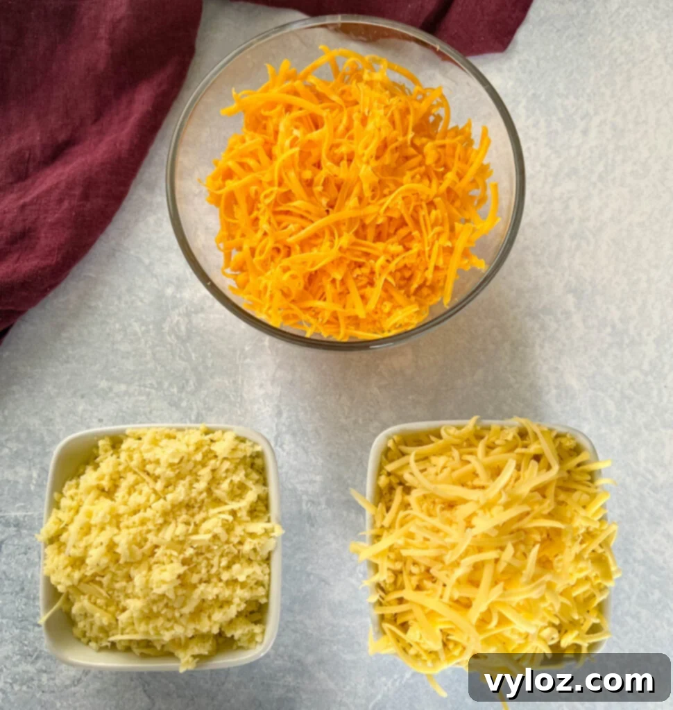 cheddar cheese, gouda cheese, and Gruyère cheese in separate bowls