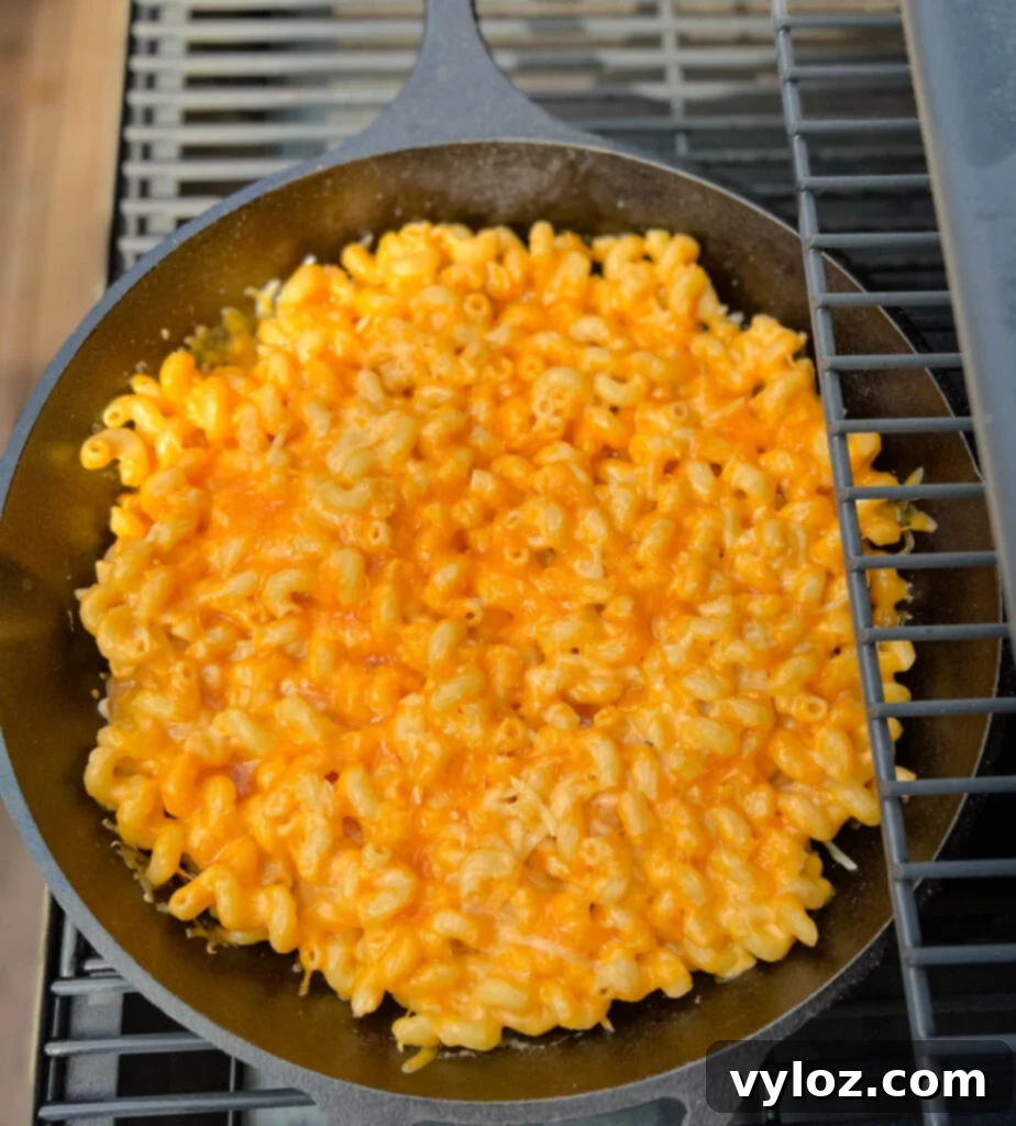 smoked mac and cheese in a cast iron skillet on a Traeger smoker