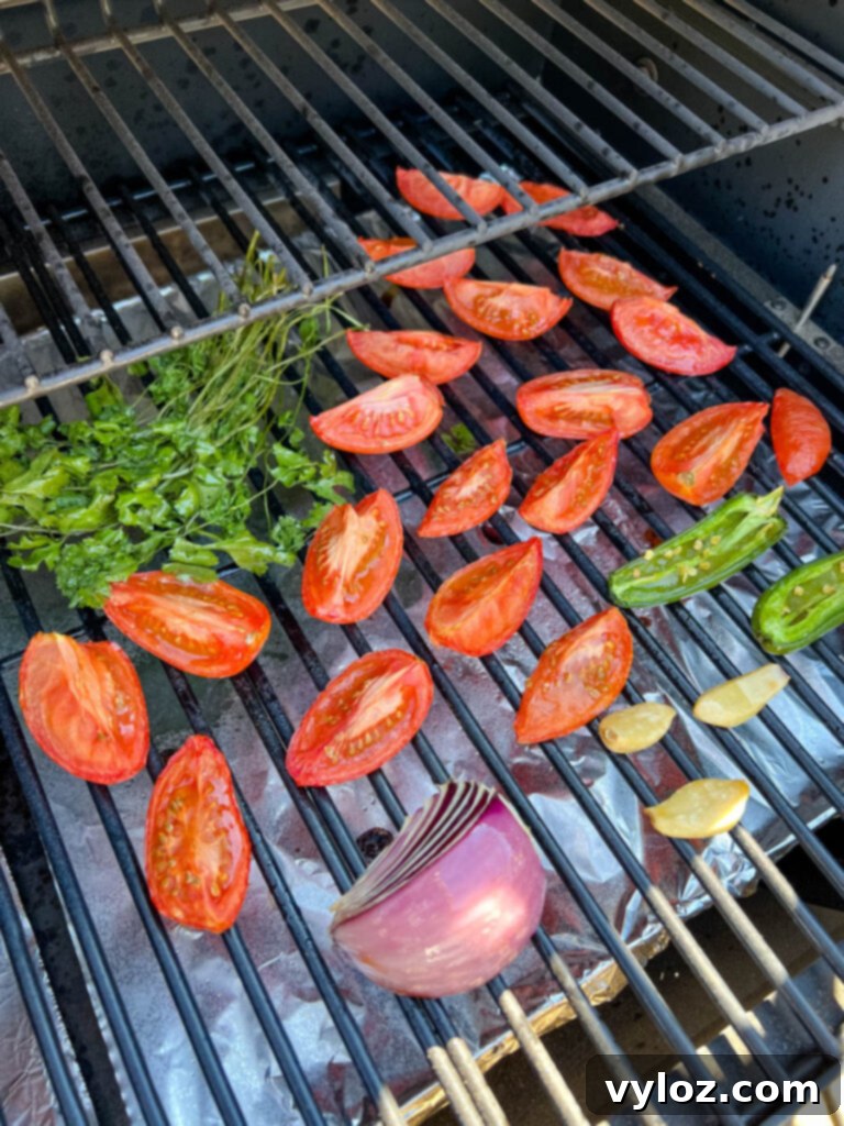 Smoky Salsa Secrets 7 A close-up view of perfectly smoked tomatoes, red onions, garlic, and cilantro, glistening with smoky goodness on a Traeger smoker grate.