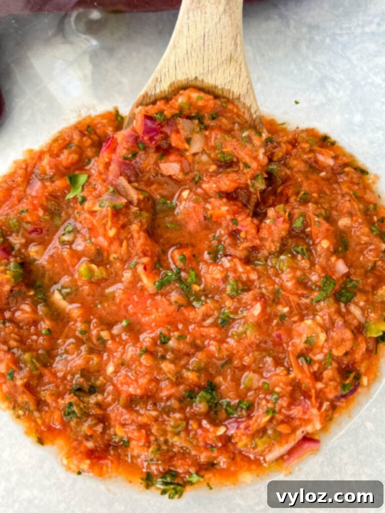 Smoky Salsa Secrets 9 Smoked salsa presented in a clear glass bowl, showcasing its vibrant color and chunky texture, perfect for dipping.