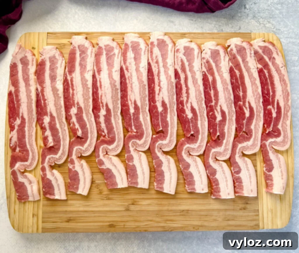 Ultimate Traeger Smoked Bacon 3 uncooked thick bacon on a cutting board