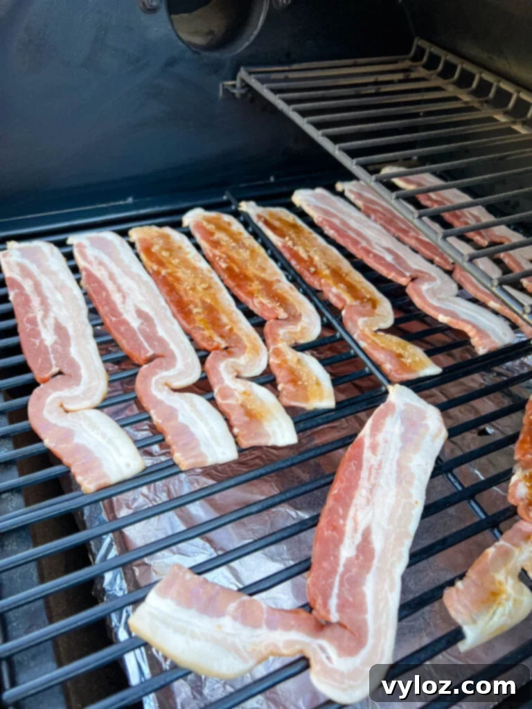 Ultimate Traeger Smoked Bacon 8 uncooked bacon on a Traeger smoker