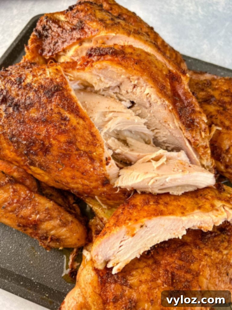 Smoked Spatchcock Turkey on the Traeger 11 Slices of smoked turkey breast beautifully arranged on a flat cutting board.