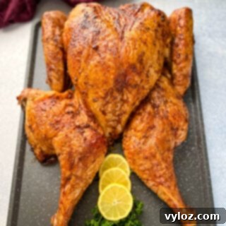 Smoked Spatchcock Turkey on the Traeger 12 smoked turkey with lemons and parsley on a table