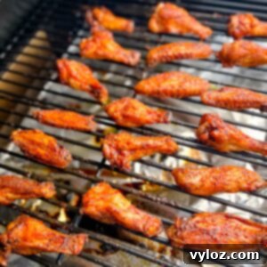 Cooked chicken wings on a Traeger smoker pellet grill, showcasing their irresistible crispiness