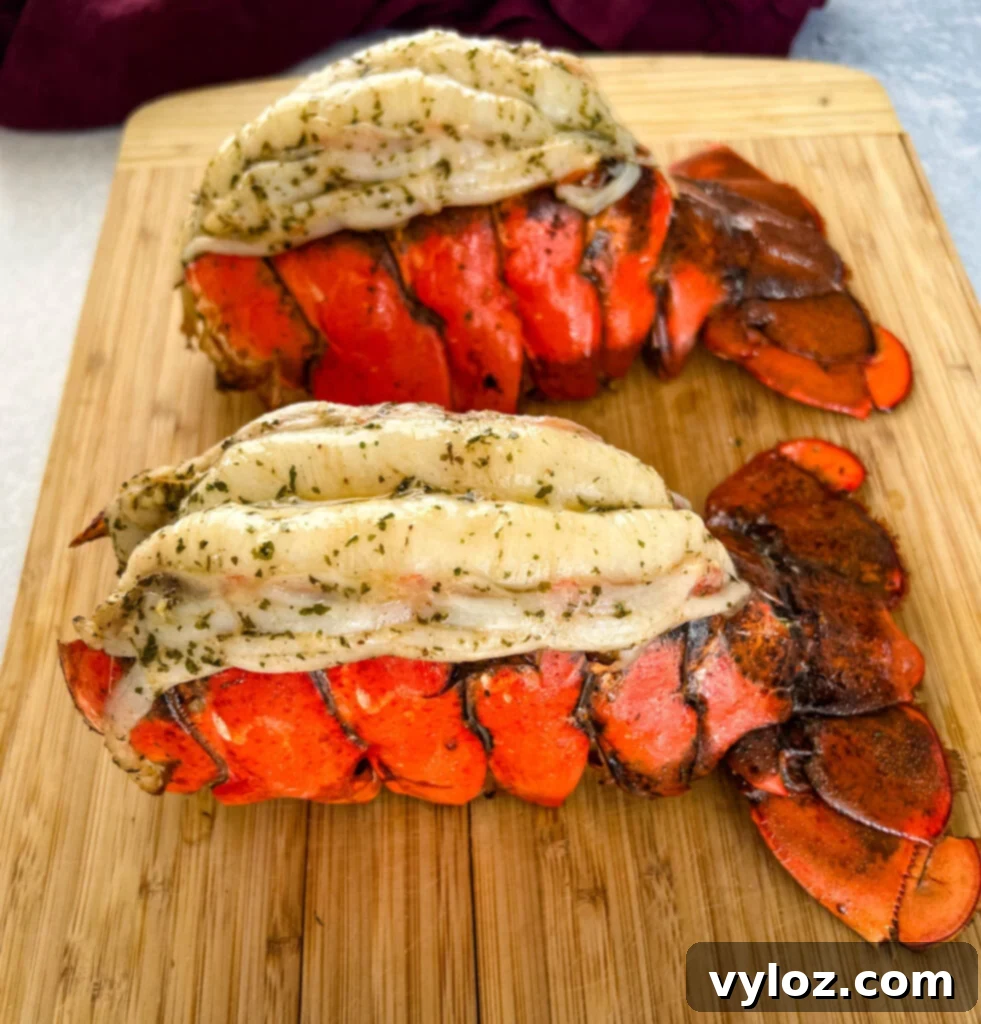Effortless Smoked Lobster Tails 2 Smoked lobster tails artfully arranged on a rustic cutting board, ready to be enjoyed.