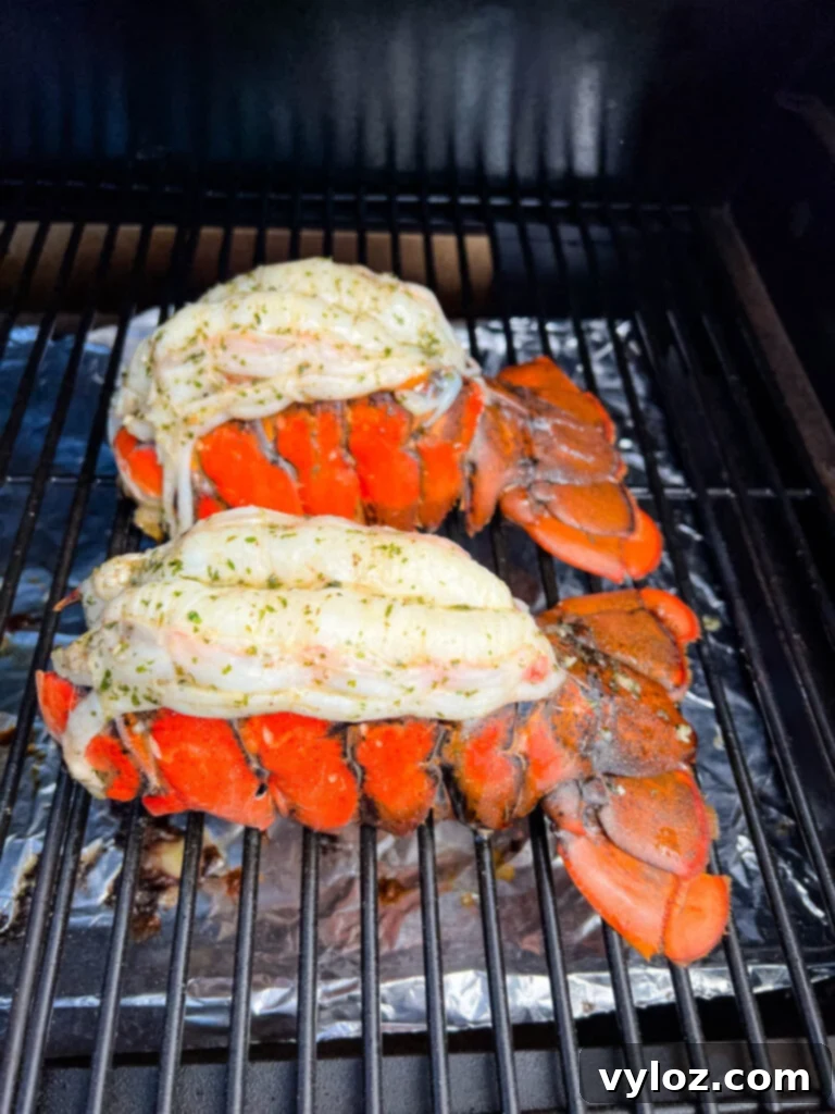 Effortless Smoked Lobster Tails 10 Freshly smoked lobster tails, vibrant red, cooling on the grates of a smoker after cooking.