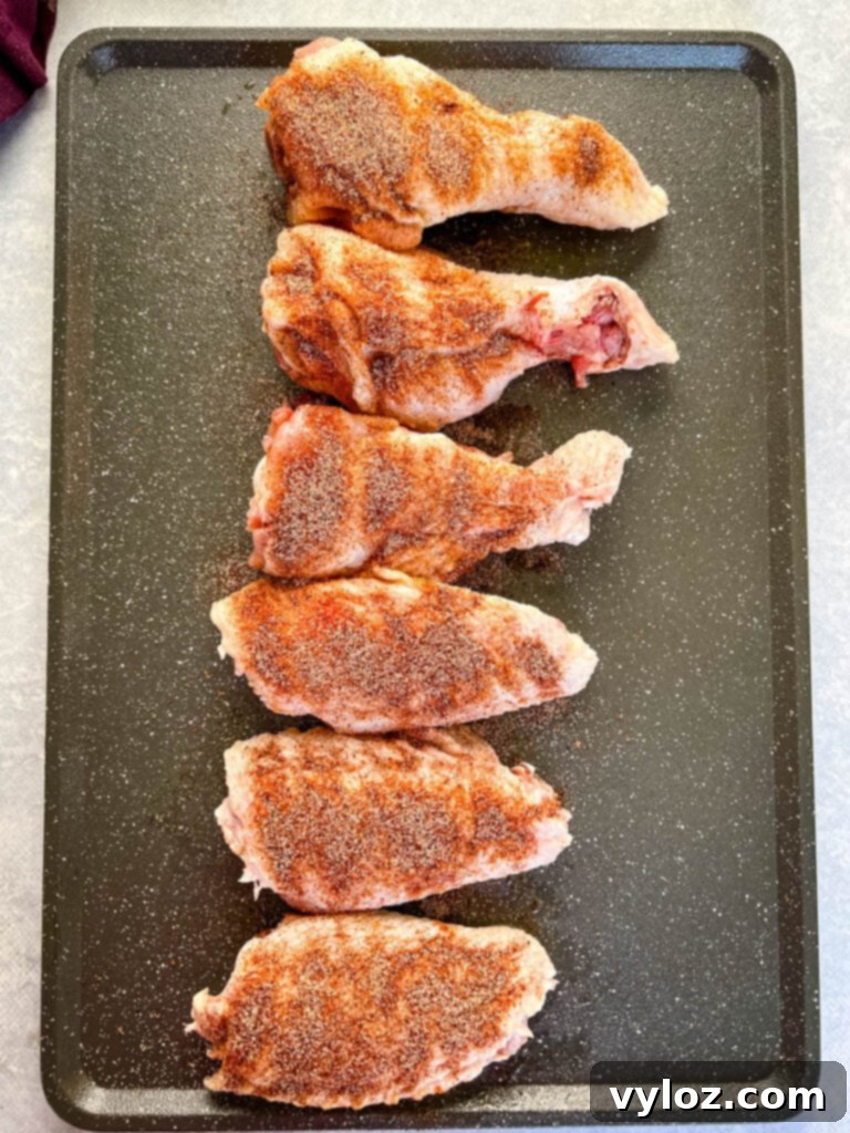 raw, seasoned turkey wings on a platter