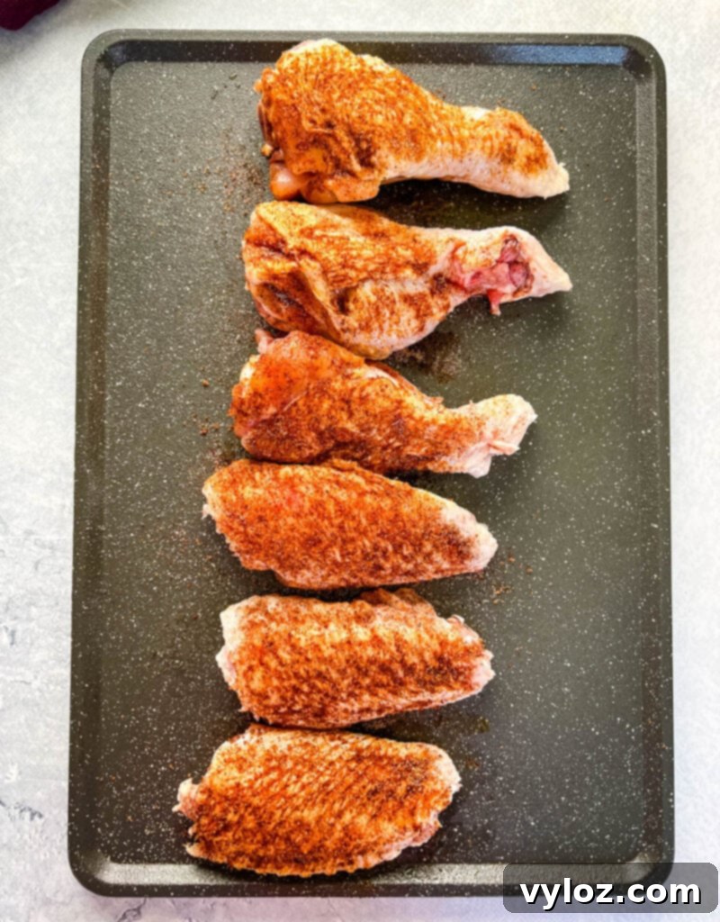 raw, seasoned turkey wings arranged on a flat surface