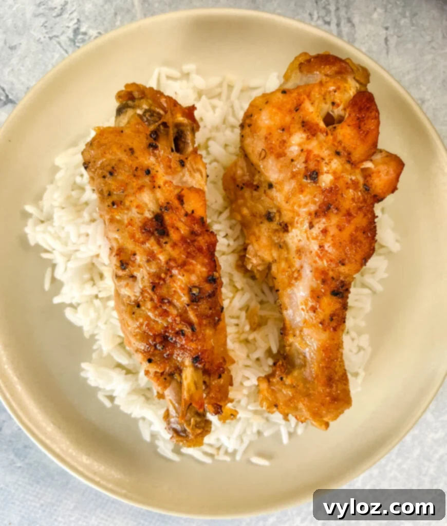 slow cooker turkey wings on a plate with white rice