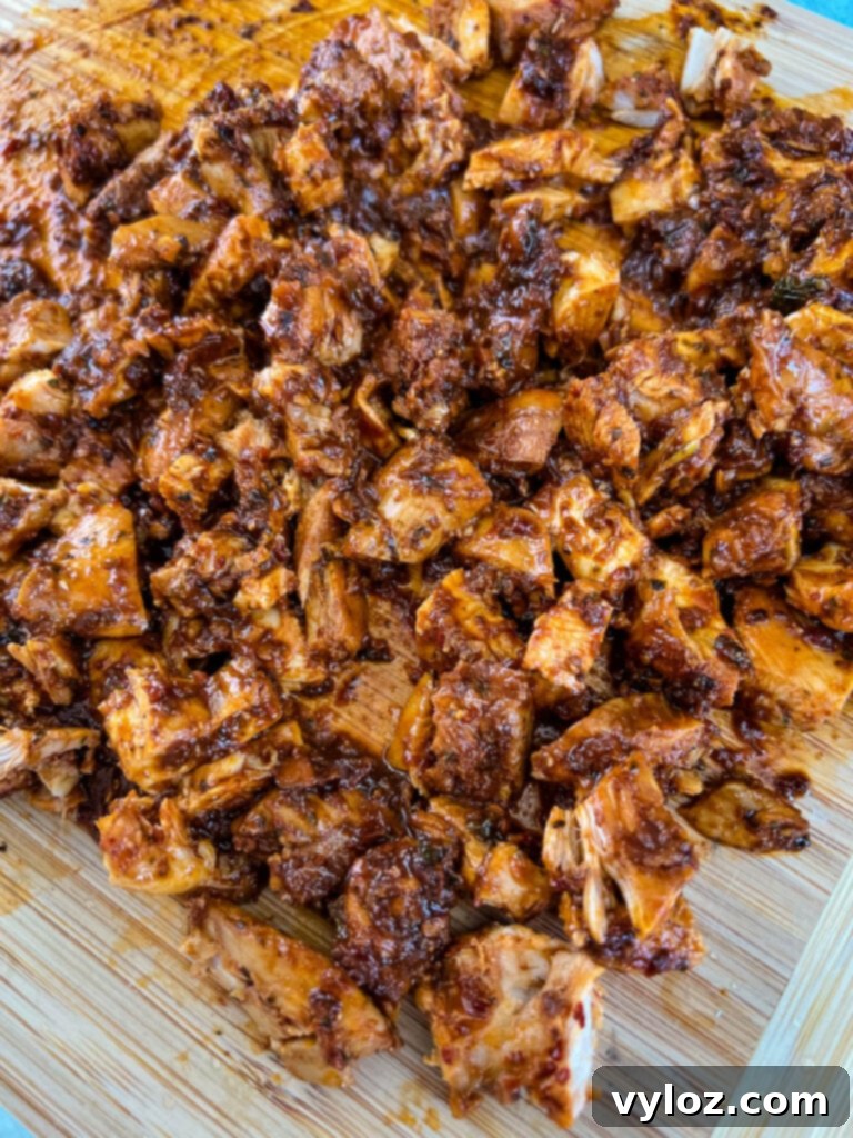 pollo asado on a cutting board with sauce