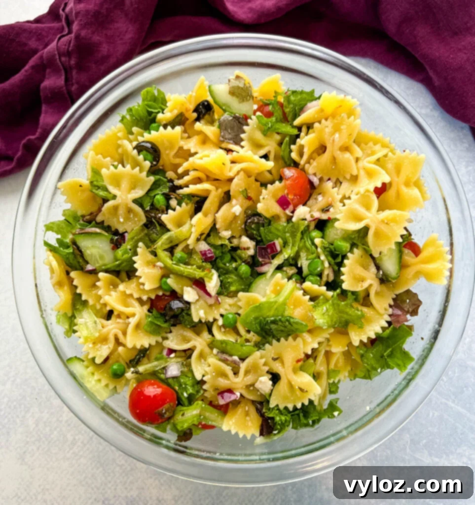 Zesty Bow Tie Pasta Salad 11 bow tie farfalle pasta salad with vegetables with Italian dressing in a glass bowl bowl