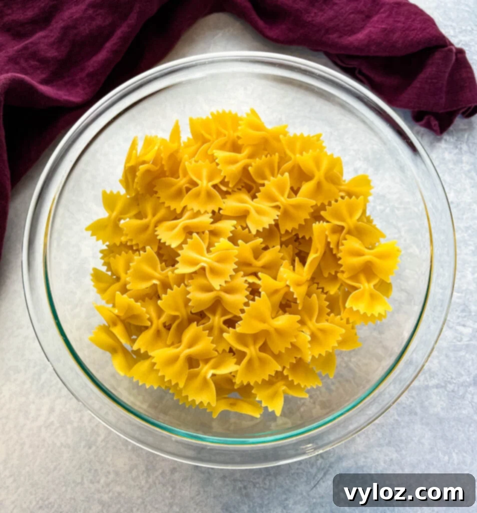 Zesty Bow Tie Pasta Salad 3 uncooked farfalle bow tie pasta in a bowl