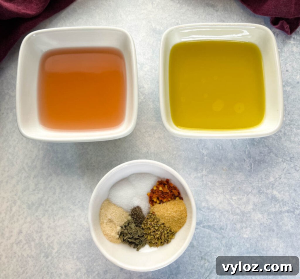 vinegar, olive oil, and various spices arranged in separate bowls