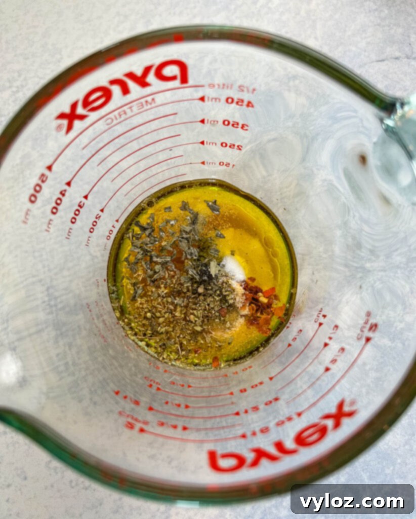 Italian Vinaigrette dressing in a clear glass cup
