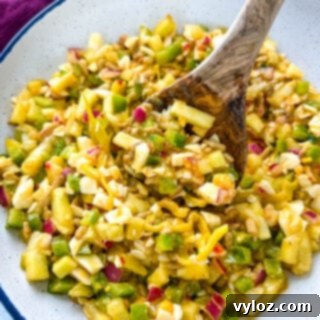 Your Go-To Hot Girl Summer Salad 9 Hot Girl Summer Salad (TikTok Viral Recipe) in a white bowl with a wooden spoon