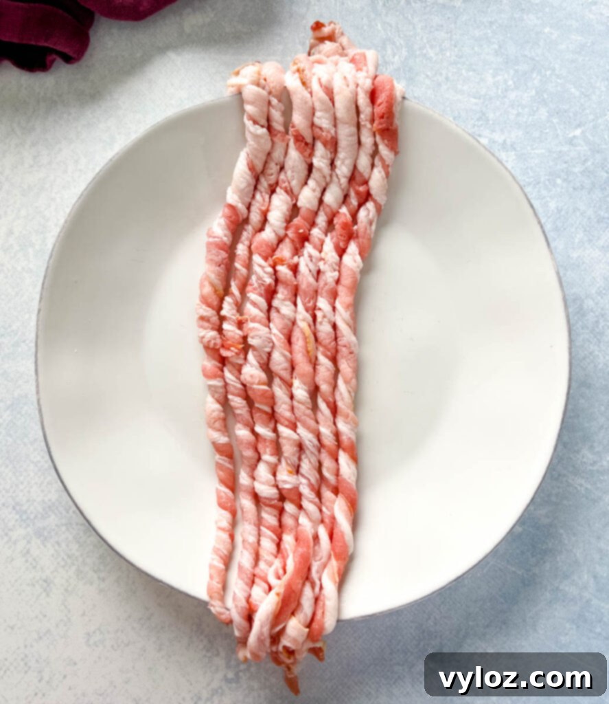 uncooked twisted bacon on a white plate