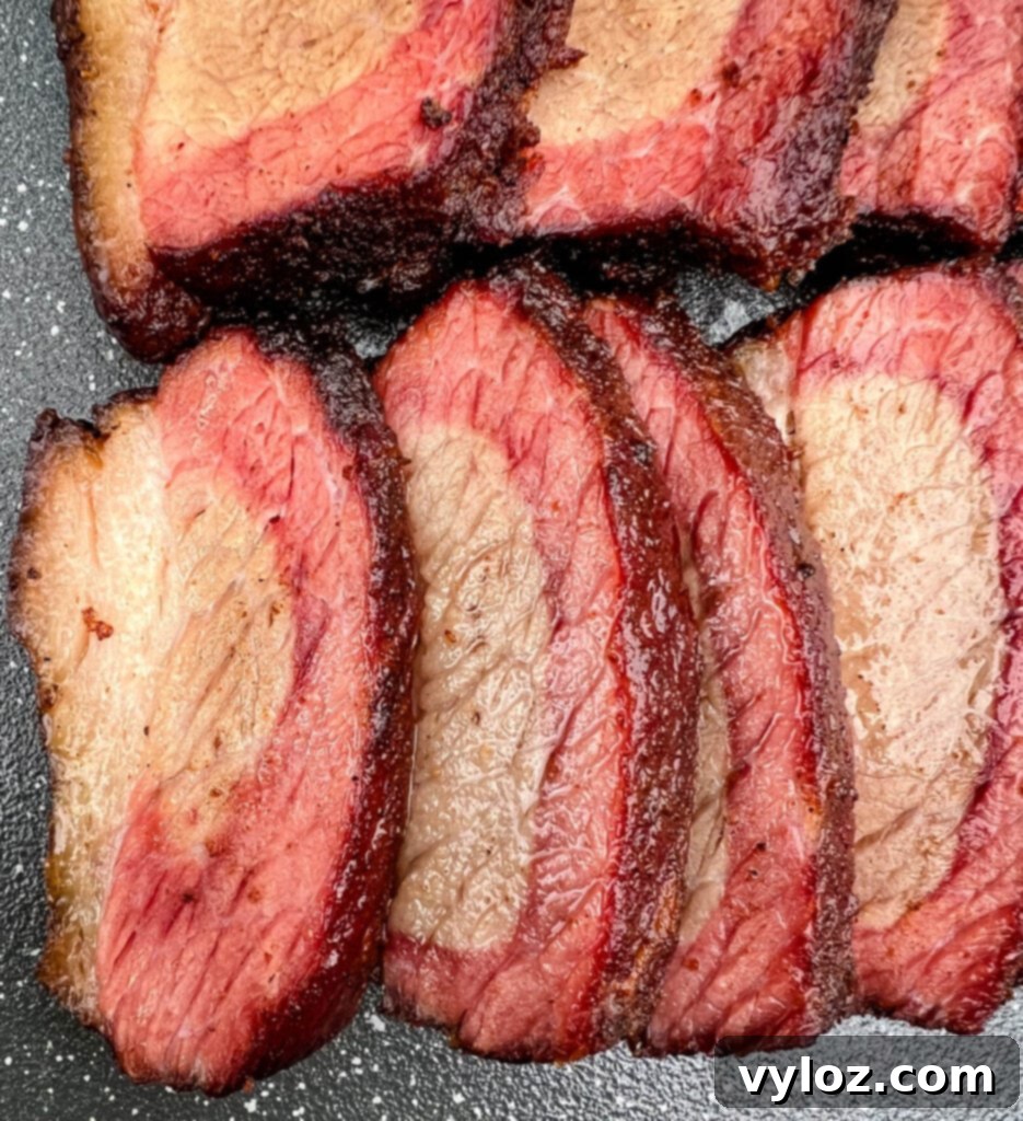 Traeger smoked brisket, beautifully sliced and served on a plate, ready to be enjoyed.