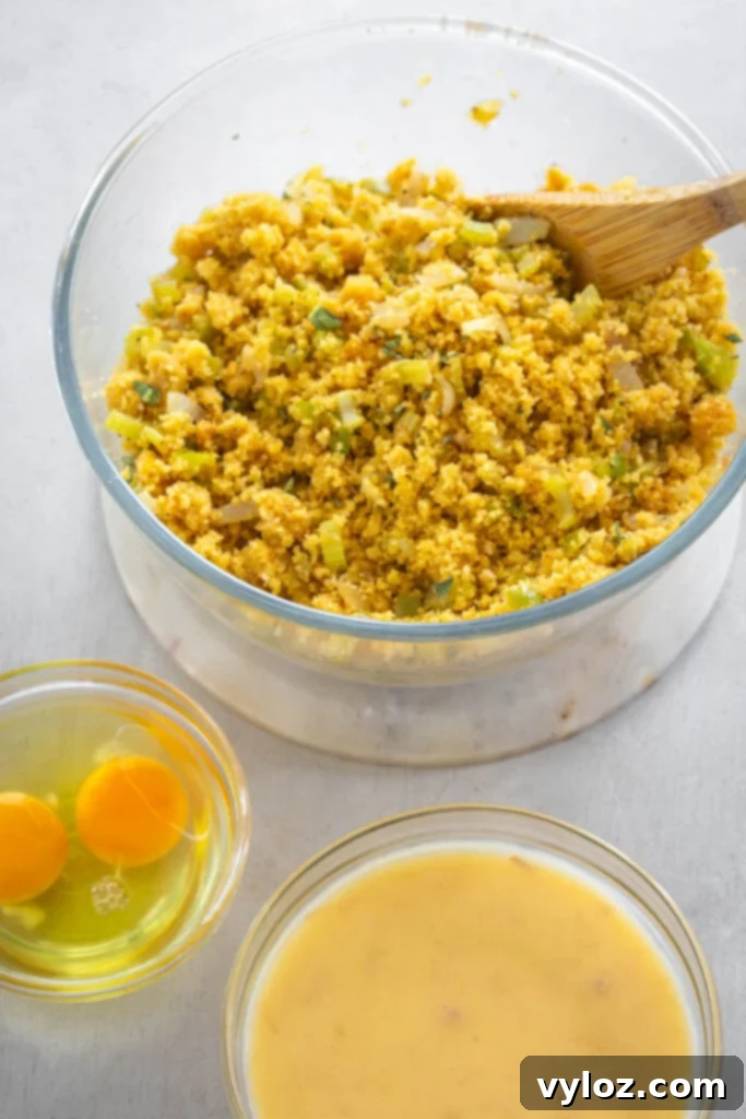 The Ultimate Seafood Dressing 6 Bowls containing cooked cornbread, raw eggs, and cream of chicken soup, ready to be combined for the dressing.