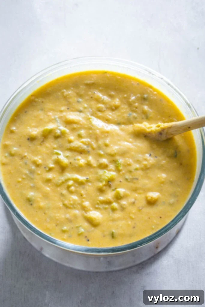 The Ultimate Seafood Dressing 7 Seafood cornbread dressing batter in a mixing bowl, showing its moist and cohesive consistency.