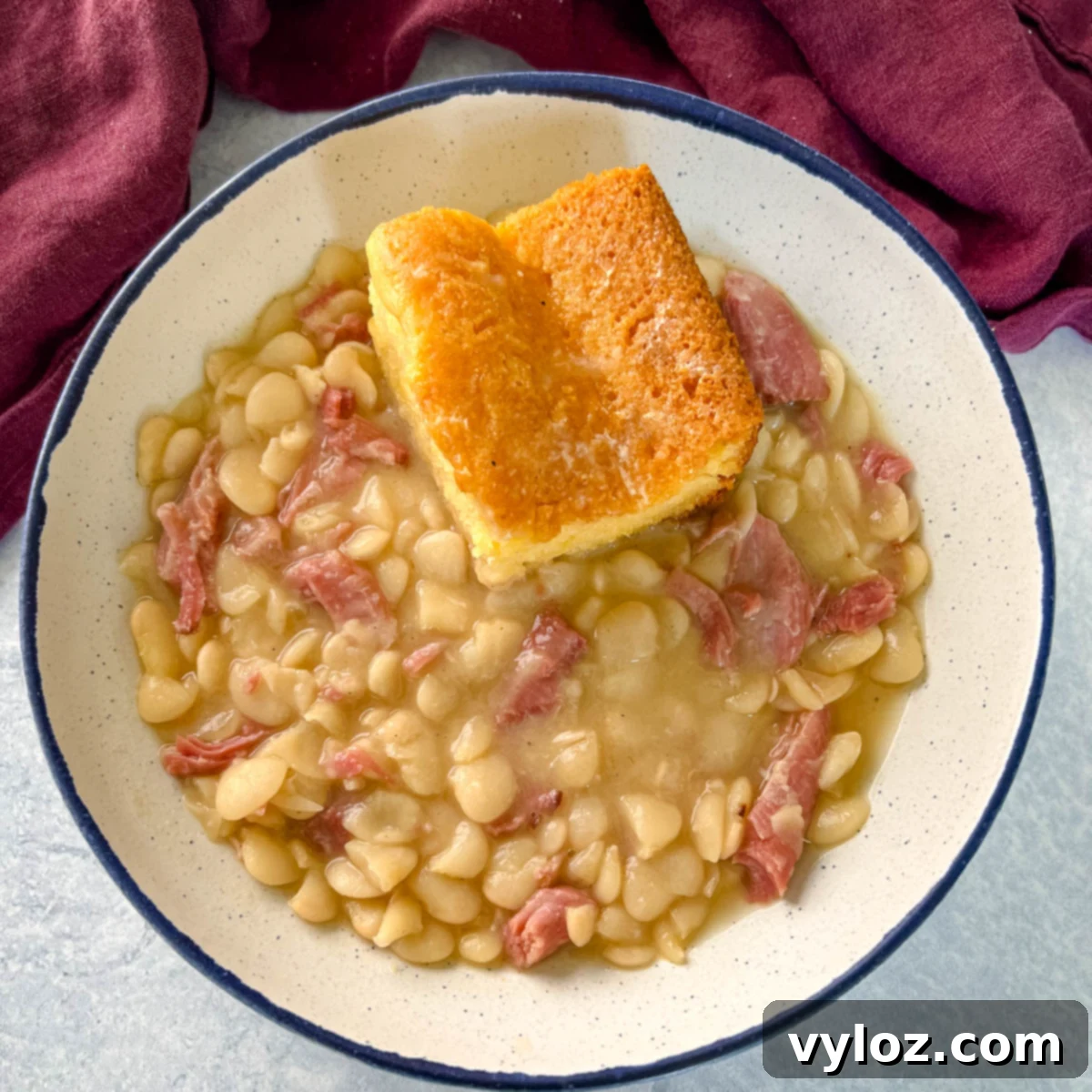 Southern butter lima beans in a bowl with cornbread, a true comfort food classic.