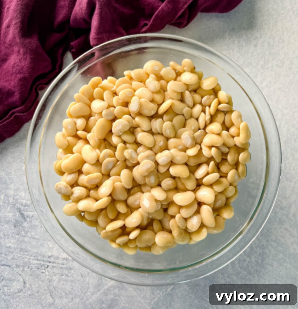 A bowl filled with dried lima beans, the essential ingredient for this comforting Southern dish.