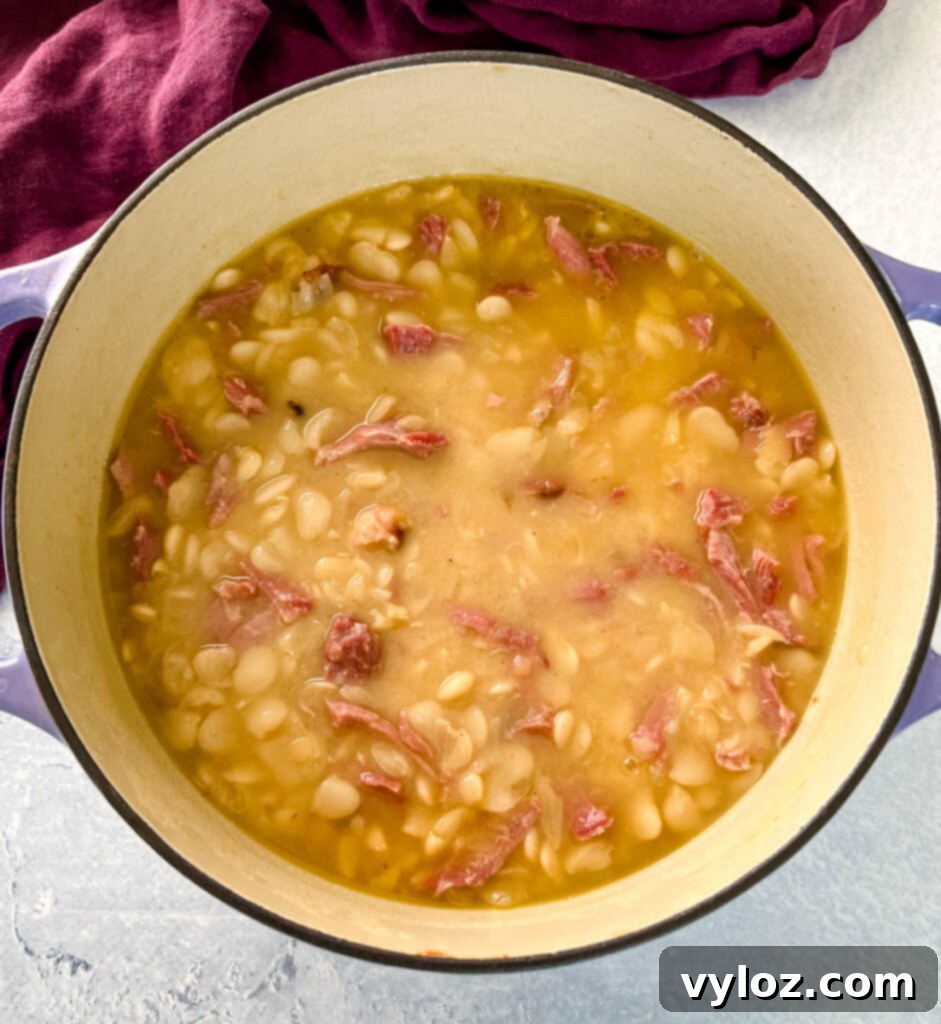 A Dutch oven filled with Southern butter lima beans, simmering to perfection.