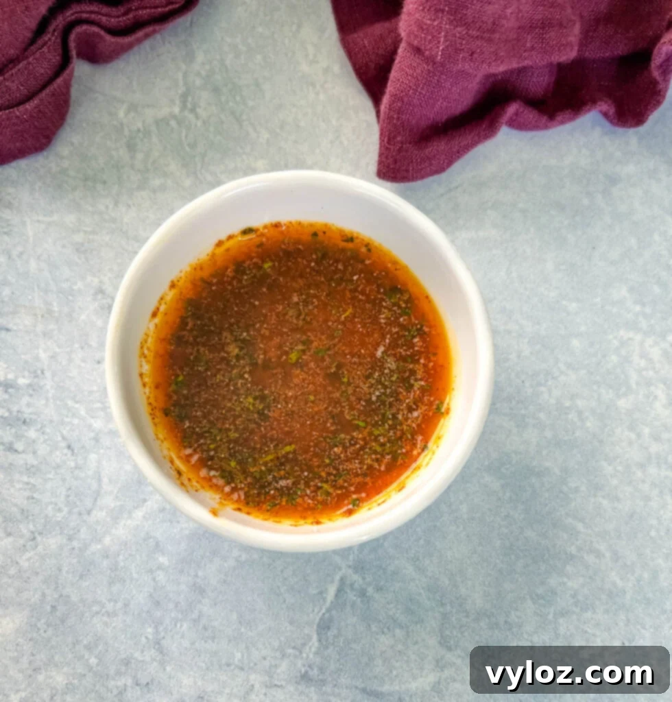 A bowl of garlic butter sauce, ready to be drizzled over corn