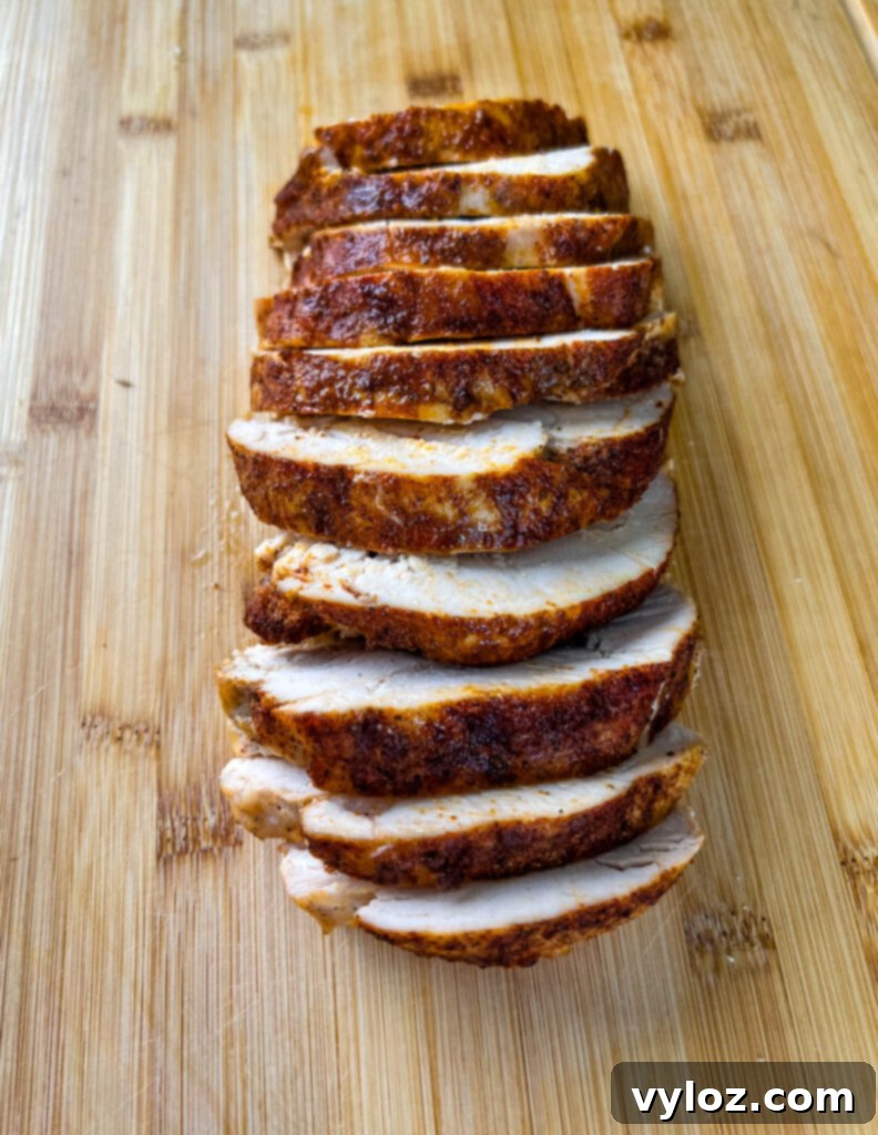 Beautifully sliced boneless turkey breast on a bamboo cutting board, ready for serving